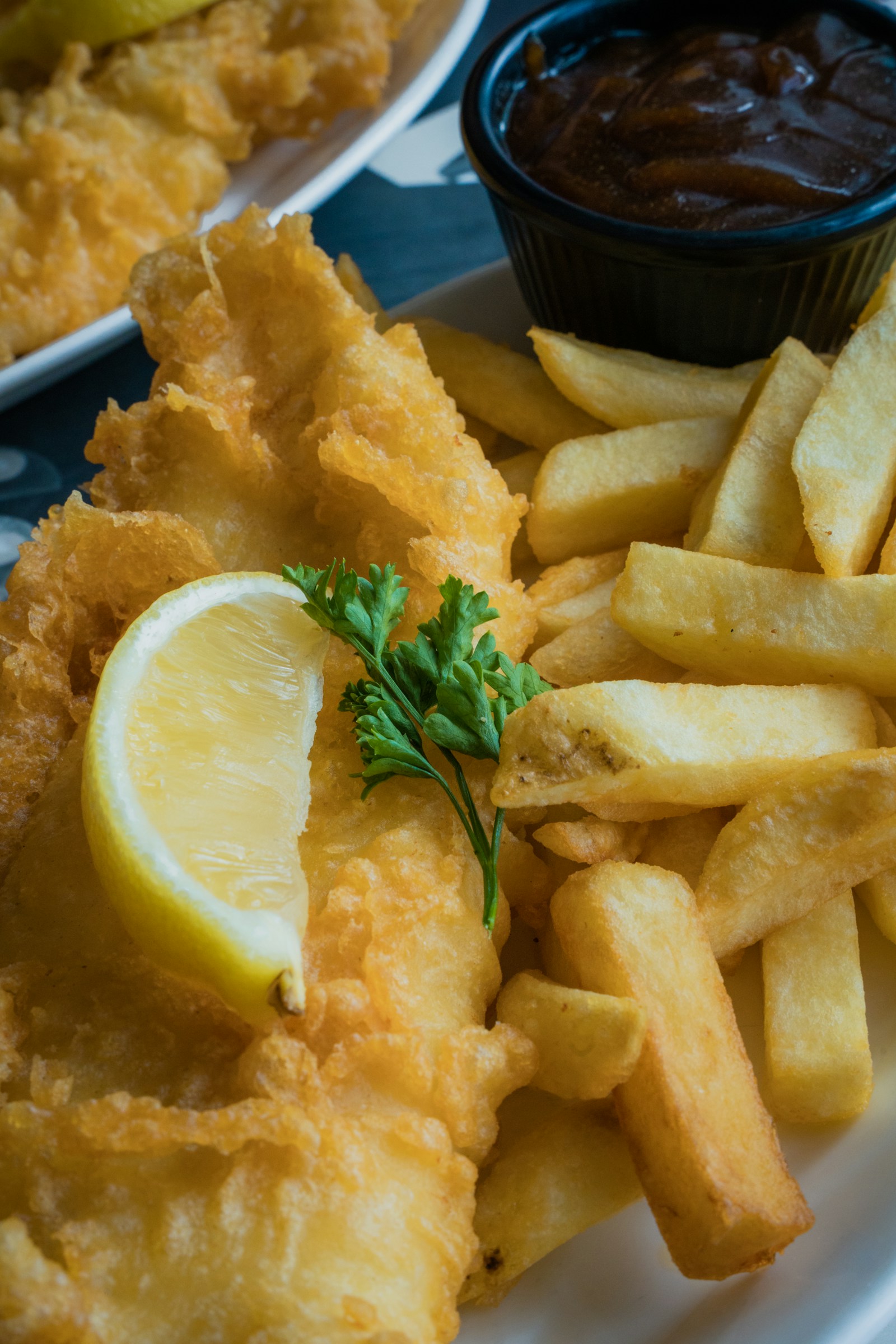 Battered cod with thick-cut chips, lemon and parsley