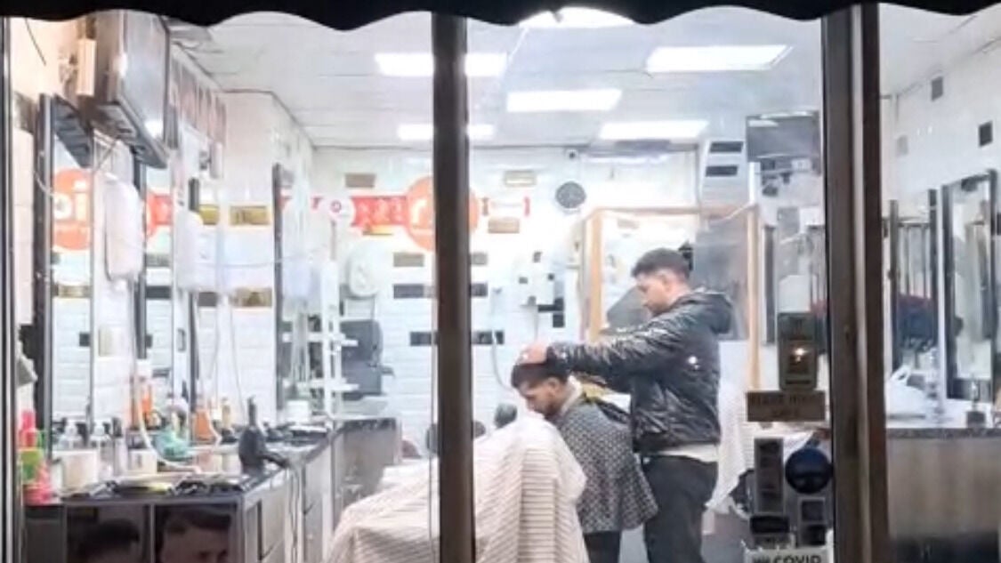 Haircut session under warm lighting at Harryliz Barbers