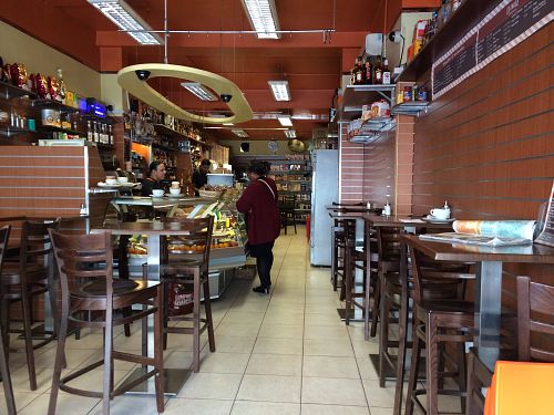 La Cigale interior with deli counter, espresso machine and limited high-top seating