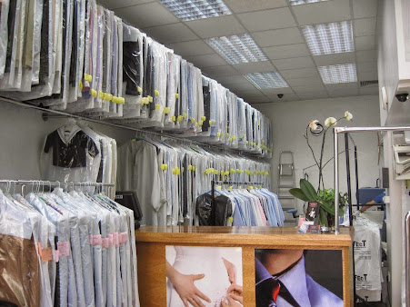 Garment rails and service counter inside Perfect Dry Cleaners