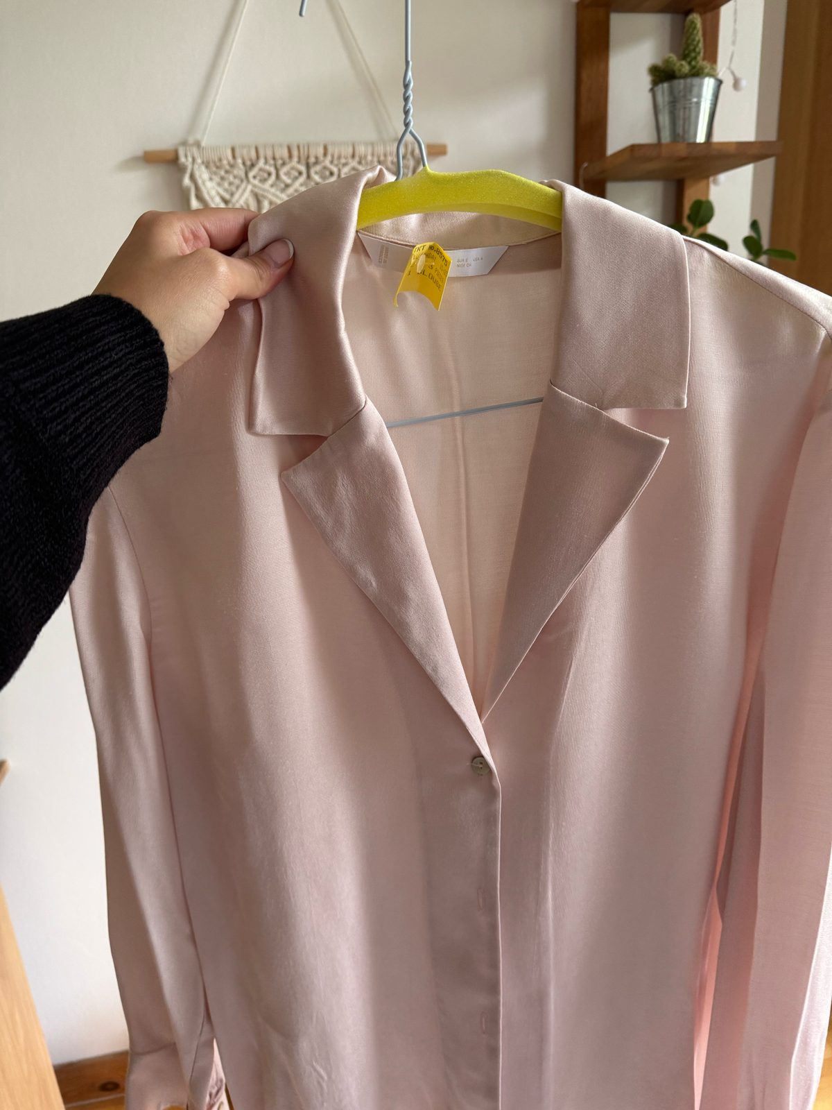 Freshly cleaned blouse with Perfect Dry Cleaners care tag