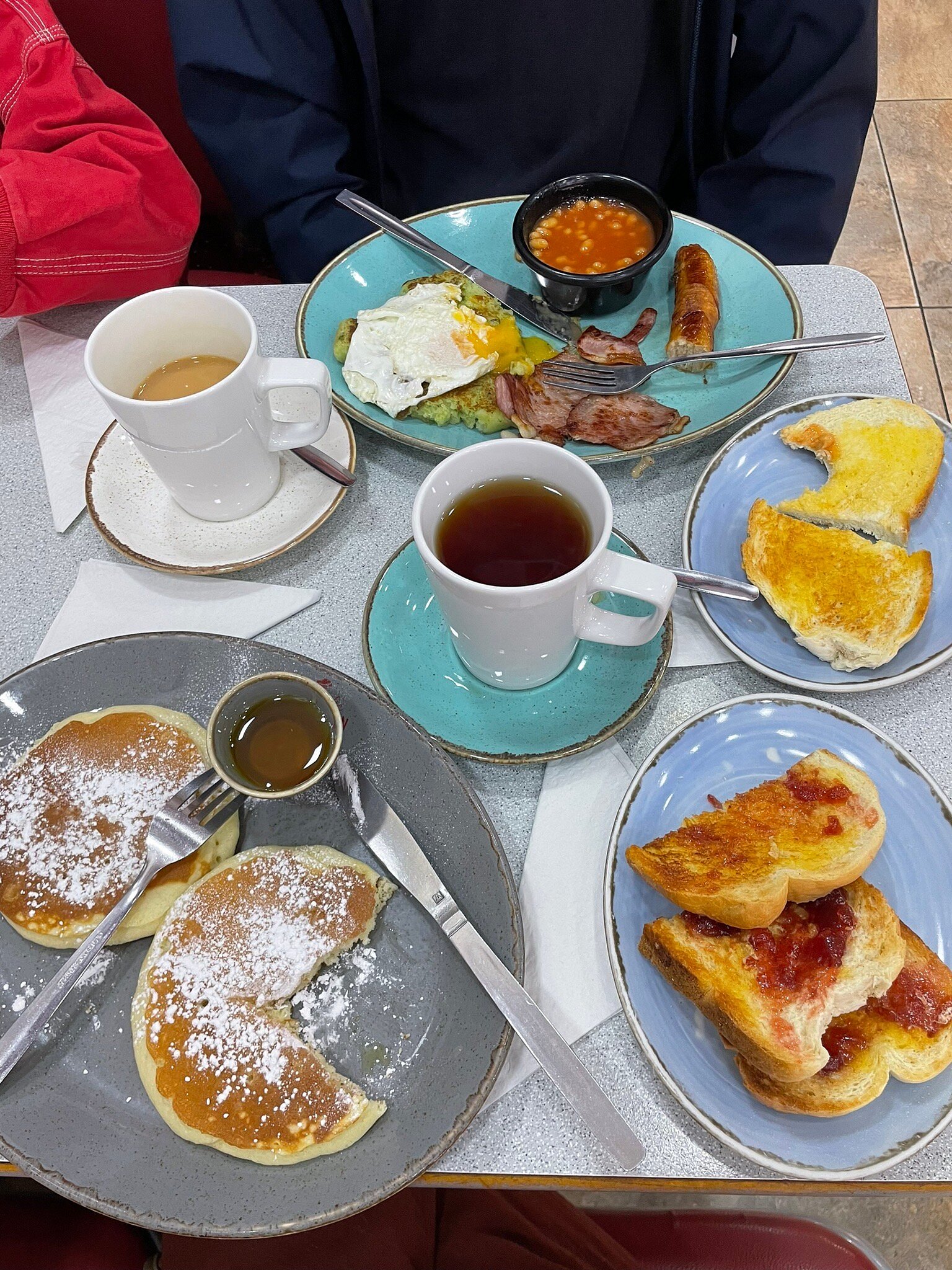 Breakfast plates and drinks on a table at Pop Inn Cafe