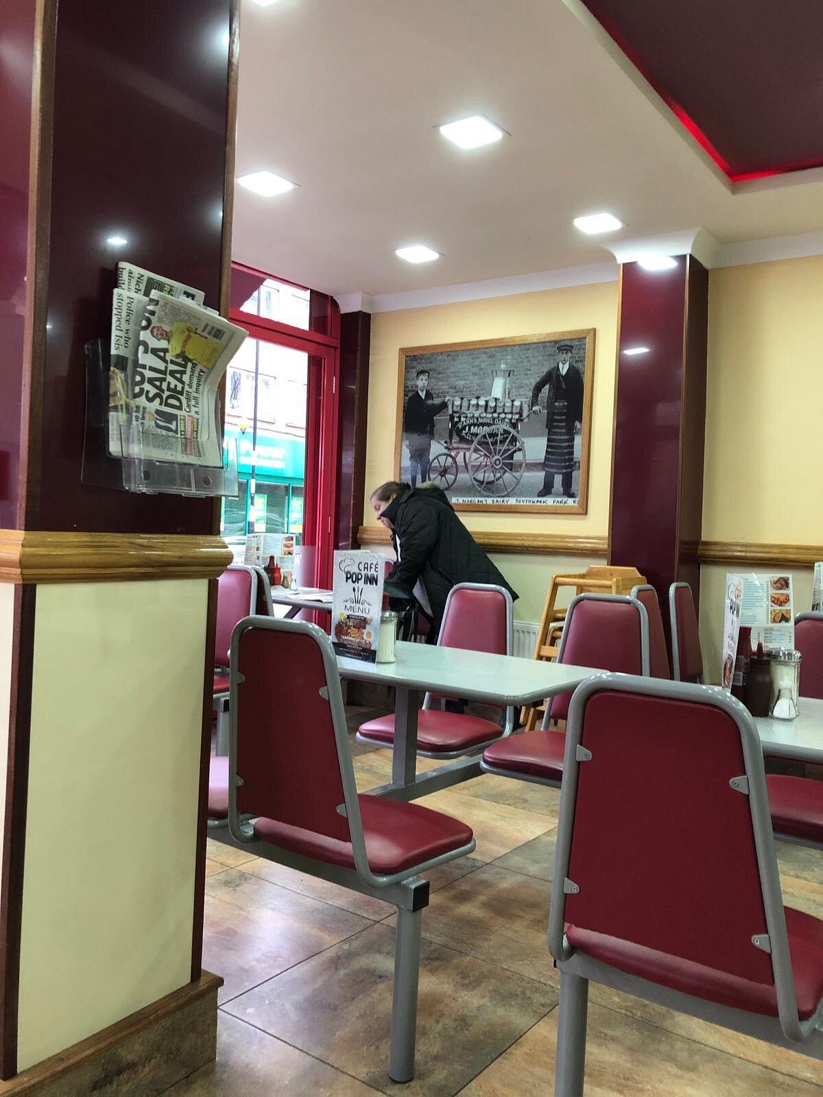 Red chairs and formica tables inside Pop Inn Cafe