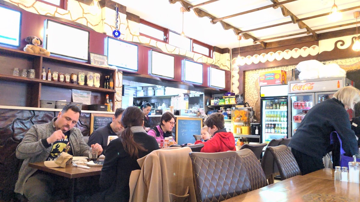 Busy café interior with quilted chairs and counter